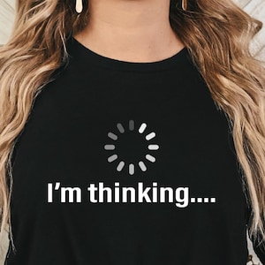 May include: Black t-shirt with a white loading icon and the text "I'm thinking..."