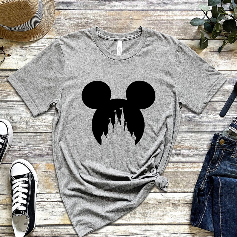 May include: A gray t-shirt with a black silhouette of Mickey Mouse's head with the silhouette of Cinderella's castle inside the ears.