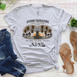 May include: A light gray t-shirt featuring a family tree design with the text "Byrom Varnadore Family Reunion 2026." The design includes silhouettes of family members and the phrase "Our Story Our Roots One Love." The shirt also displays "NJ/NY."