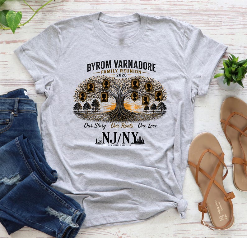 May include: A light gray t-shirt featuring a family tree design with the text "Byrom Varnadore Family Reunion 2026." The design includes silhouettes of family members and the phrase "Our Story Our Roots One Love." The shirt also displays "NJ/NY."