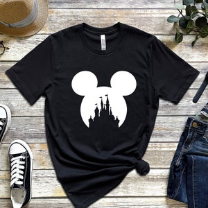 May include: Black t-shirt with a white silhouette of Mickey Mouse ears with a castle inside the ears.