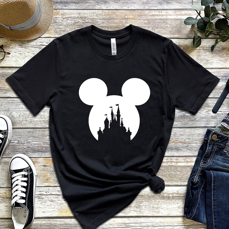 May include: Black t-shirt with a white silhouette of Mickey Mouse ears with a castle inside the ears.