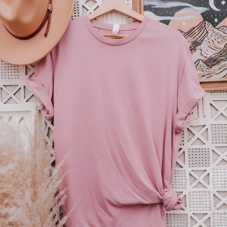 May include: A plain, dusty rose colored t-shirt with rolled up sleeves. The t-shirt is made of a soft, comfortable material.