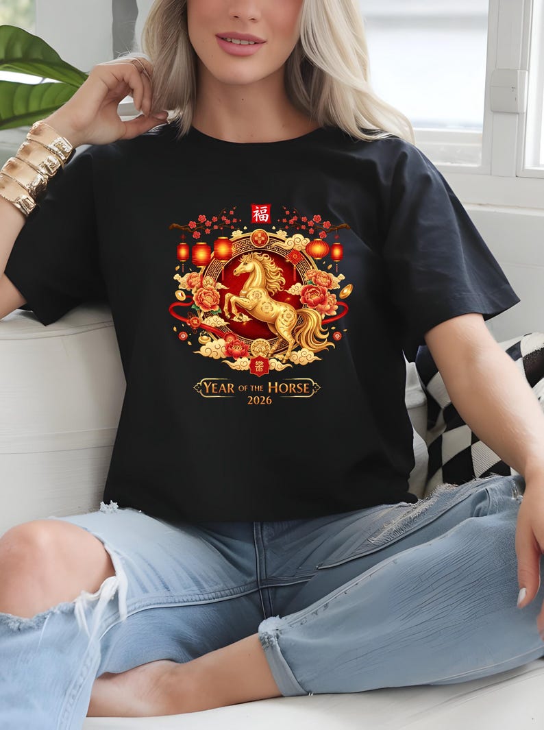 May include: Black t-shirt featuring a golden horse design within a circular frame with red and gold accents. The design includes Chinese characters and the text "YEAR OF THE HORSE 2026".
