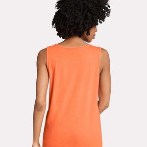 May include: A sleeveless tank top in a solid, vibrant orange color. The garment features a simple round neckline and a straight hemline, providing a clean and basic silhouette. The fabric appears to be a lightweight, smooth cotton-blend material.