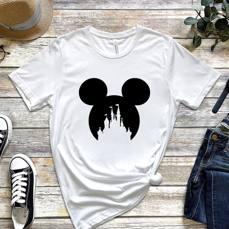 May include: White t-shirt with a black silhouette of Mickey Mouse's head with the silhouette of Cinderella's castle inside the ears.