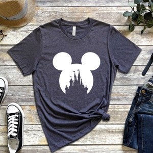May include: A dark gray t-shirt with a white silhouette of Mickey Mouse's head with the silhouette of Cinderella's castle inside the ears.