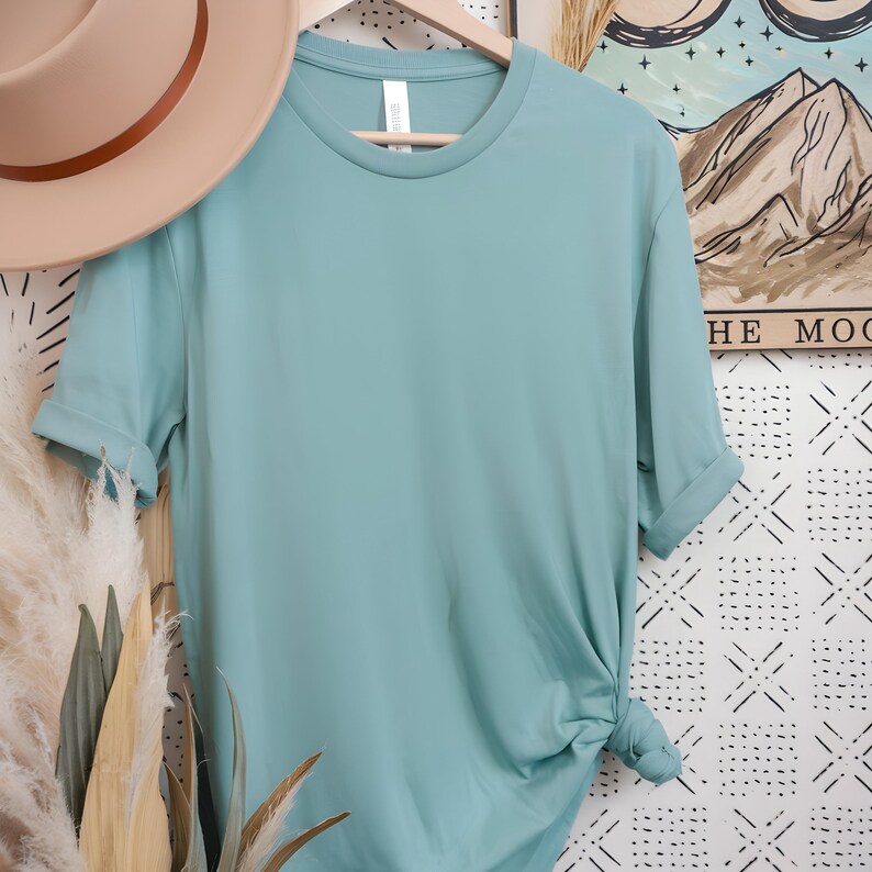 May include: A light blue t-shirt with a crew neck and short sleeves. The shirt is made of a soft, comfortable material.