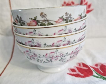 Antique white porcelain bowl with various floral patterns and gold edging, medium size