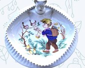 A vintage baby heated plate in porcelain GL Limoges boy pattern with birds and eggs