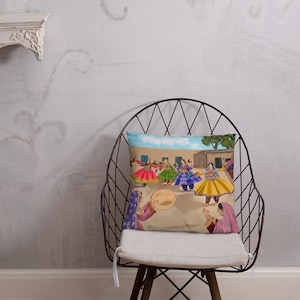 May include: A throw pillow featuring a colorful illustration of women in traditional clothing dancing in a circle. The women are wearing vibrant colors, including pink, yellow, blue, and green. The background is a simple landscape with a blue sky and a few trees.