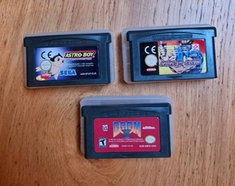 Three Game Action Value Bundle - Nintendo Game Boy Advance. GBA Carts With Cases: Astro Boy, Doom 2, and Ninja Cop / Ninja Five-0