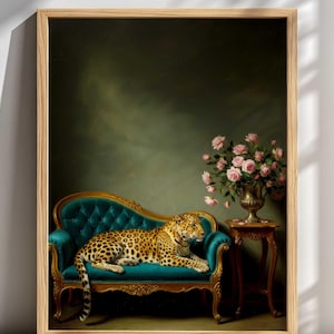 Op de afbeelding: Een ingelijste print met een luipaard dat rust op een turquoise chaise longue. Het luipaard heeft een gevlekte vacht. Een vaas met roze rozen staat rechts op een kleine tafel. De achtergrond is donkergroen.