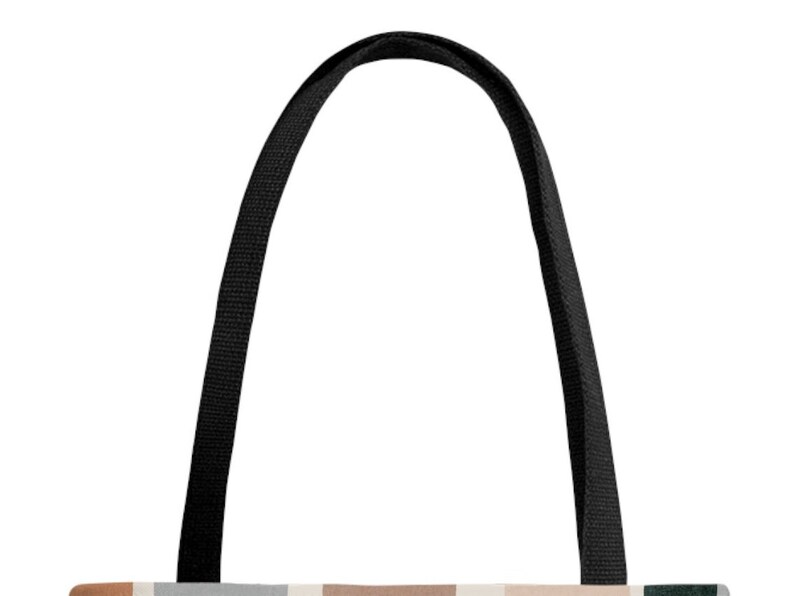 May include: Black tote bag with two long black straps. The bag is made of canvas and has a geometric pattern in shades of brown, beige, and gray.