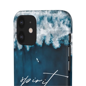 May include: A blue and white phone case with a photo of ocean waves and the word "spirit" written in white.