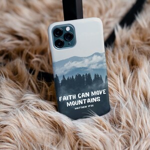 May include: A white phone case with a mountain scene and the text "Faith can move mountains Matthew 17:20".