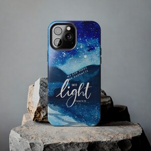May include: A blue and white phone case with a watercolor design of stars and clouds. The text "My God turns my darkness into light Psalm 18:28" is printed on the case.