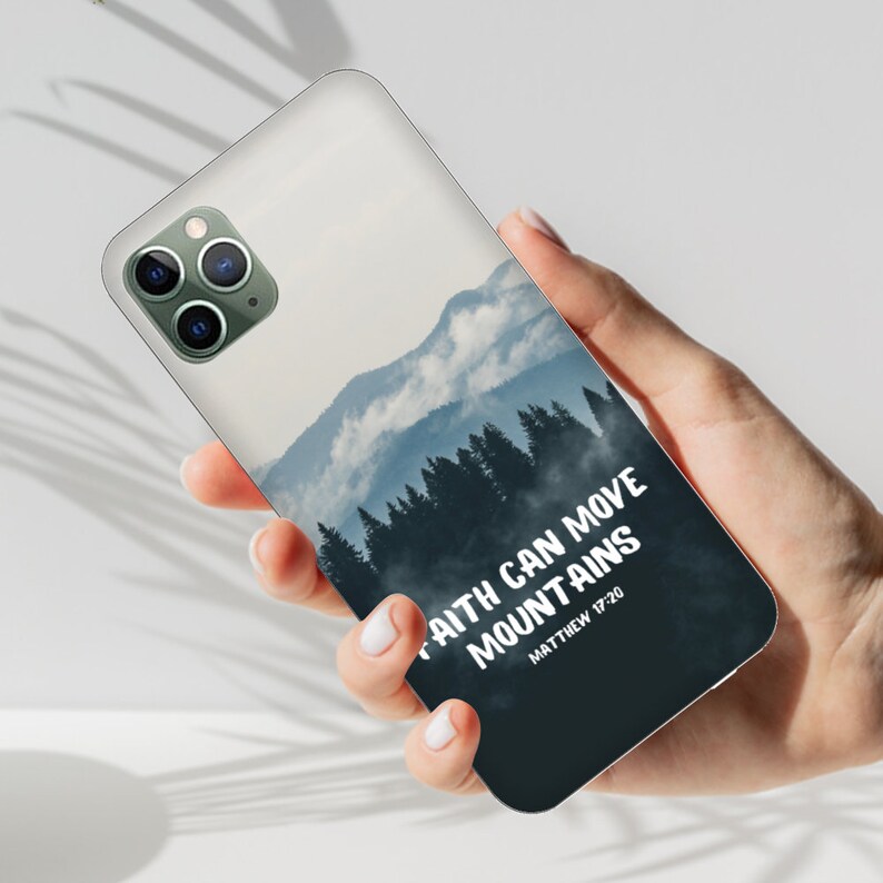 May include: A white phone case with a blue and white mountain scene and the text "Faith can move mountains Matthew 17:20".