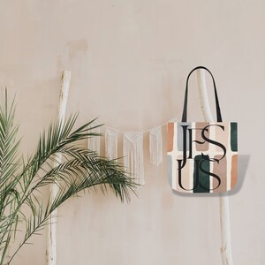May include: A tote bag with a geometric pattern in shades of brown, green, and blue. The text "JESUS" is printed in black on the bag.