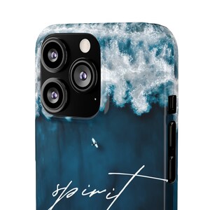 May include: A blue and white phone case with a photo of ocean waves and the word "spirit" written in white script.