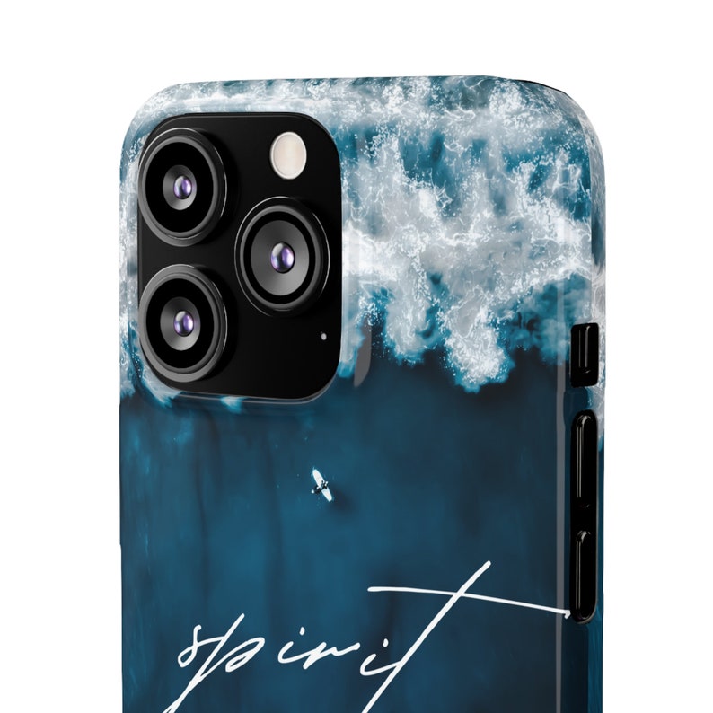 May include: A blue and white phone case with a photo of ocean waves and the word "spirit" written in white script.