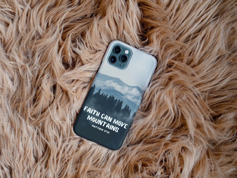 May include: A black phone case with a mountain scene and the text "Faith can move mountains" with the scripture reference "Matthew 17:20".