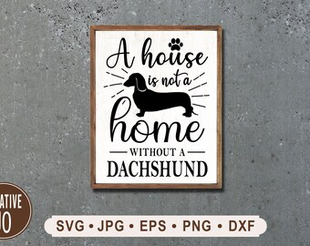 Könnte beinhalten: Ein weißes Schild mit braunem Holzrahmen trägt die Aufschrift "Ein Haus ist kein Zuhause ohne einen Dackel". Eine schwarze Silhouette eines Dackels befindet sich in der Mitte des Schildes.