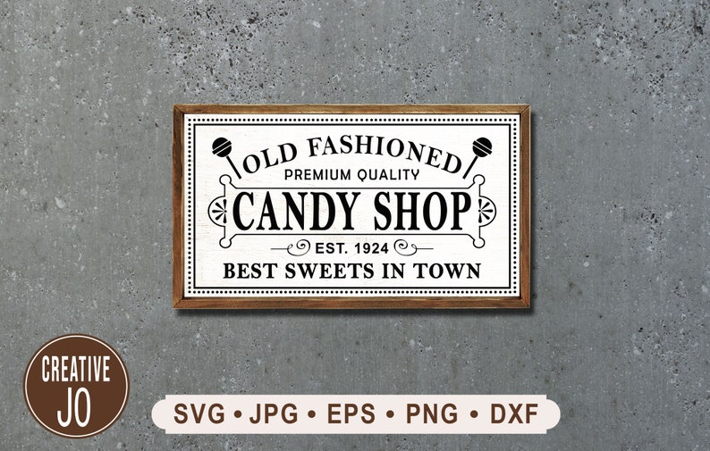 May include: A white sign with brown trim, advertising an old-fashioned candy shop. The sign reads "Old Fashioned Premium Quality Candy Shop Est. 1924 Best Sweets in Town".
