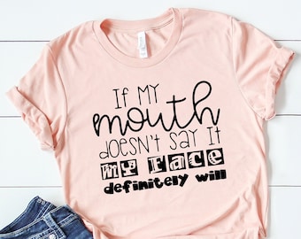 May include: A pink t-shirt with black text that reads "If my mouth doesn't say it my face definitely will."