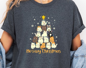 May include: Dark gray heather t-shirt with a Christmas tree design featuring a group of cats wearing Christmas lights. The text "Meowry Christmas" is printed below the tree.