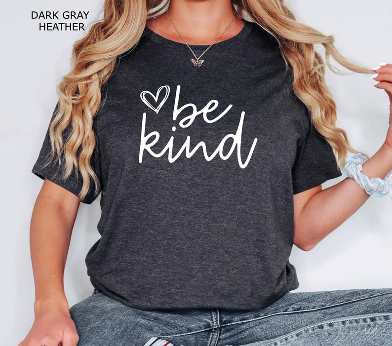 May include: A dark gray heather t-shirt with a white graphic that says "be kind" with a heart symbol.