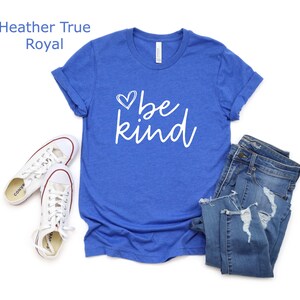 May include: A royal blue t-shirt with a white heart and the text "be kind" in a white cursive font.