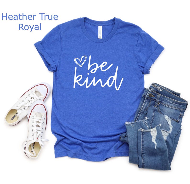 May include: A royal blue t-shirt with a white heart and the text "be kind" in a white cursive font.