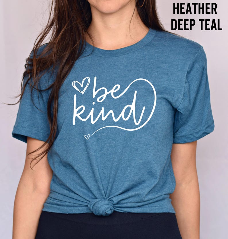 May include: A teal blue t-shirt with the text "be kind" in white lettering with a heart design.