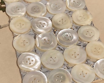 24 old mother of pearl buttons on a sample card - 27 mm