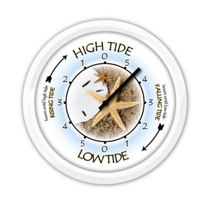 May include: White tide clock with a sandy beach scene. The clock face features a starfish and sand dollar. Text on the clock face reads "HIGH TIDE" and "LOW TIDE", with arrows indicating rising and falling tides. The clock hands point to the time.