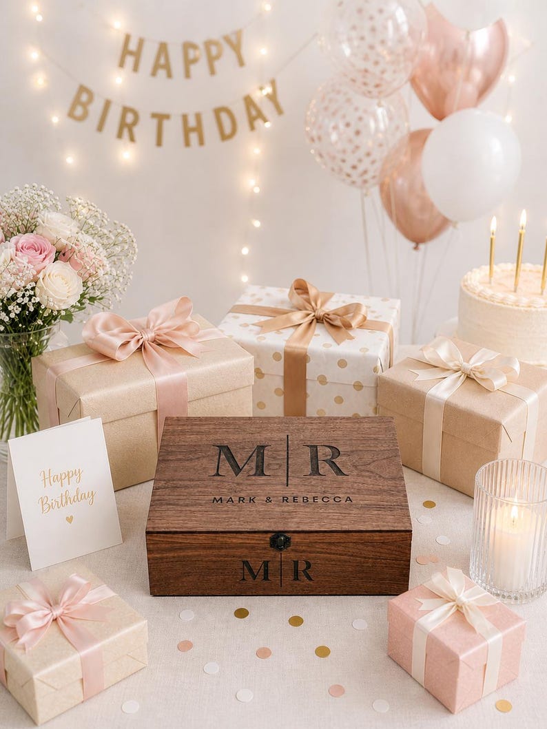 May include: A festive birthday scene with gifts, balloons, and a cake. A wooden box with "MR MARK & REBECCA" is the centerpiece, surrounded by wrapped presents with ribbons. A "Happy Birthday" banner and card add to the celebratory atmosphere.
