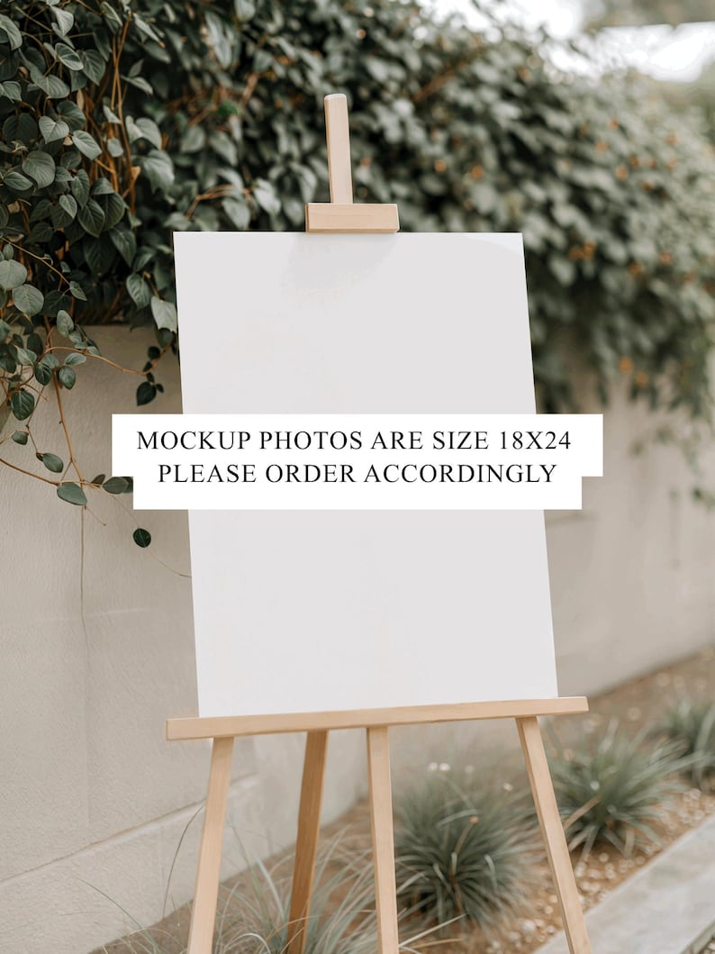 Peut inclure: Un chevalet en bois avec une toile blanche vierge, install&eacute; &agrave; l'ext&eacute;rieur devant un fond de verdure et un mur de couleur claire. Le texte sur la toile indique : "MOCKUP PHOTOS ARE SIZE 18X24 PLEASE ORDER ACCORDINGLY."