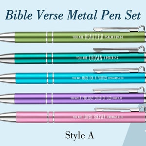 May include: Set of five metal pens with a stylus tip. Each pen has a different color and a bible verse engraved on it. The colors are green, blue, turquoise, purple, and pink. The verses are "You are beautiful Psalm 139:14", "You are chosen 1 Peter 2:9", "You are made for a purpose Ephesians 2:10", "You are a precious child of God John 1:12", and "You are loved forever Jeremiah 31:3". The pens are labeled "Style A".
