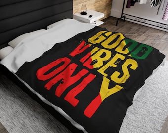 May include: Black bedspread with the words "Good Vibes Only" in yellow, red, and green lettering. The lettering is stylized and has a distressed look.