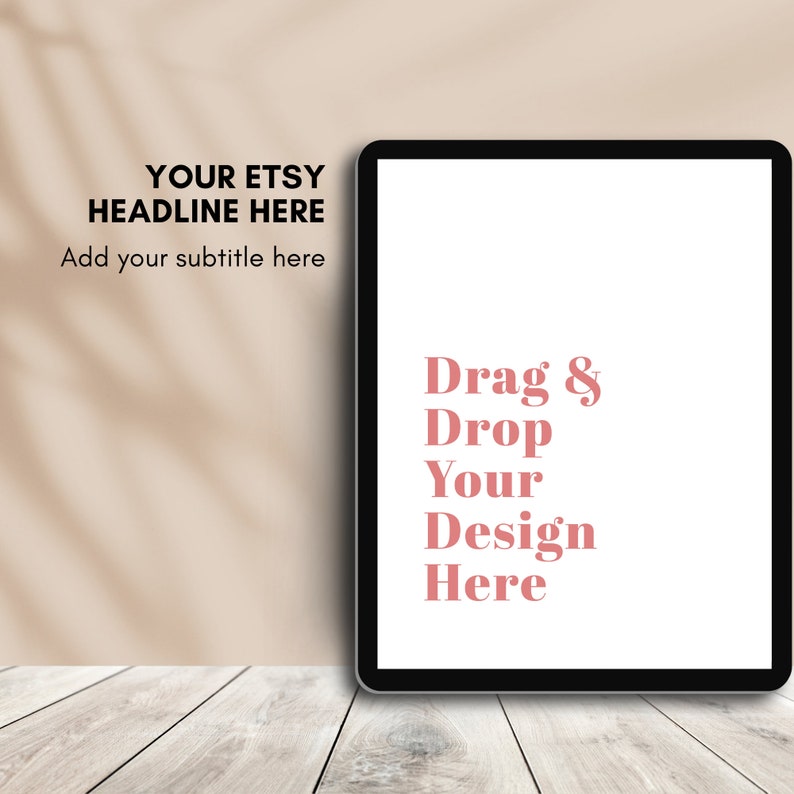 May include: A black tablet with a white screen displaying the text "Drag & Drop Your Design Here" in pink. The background features the text "YOUR ETSY HEADLINE HERE" and "Add your subtitle here". The tablet rests on a light wood surface.