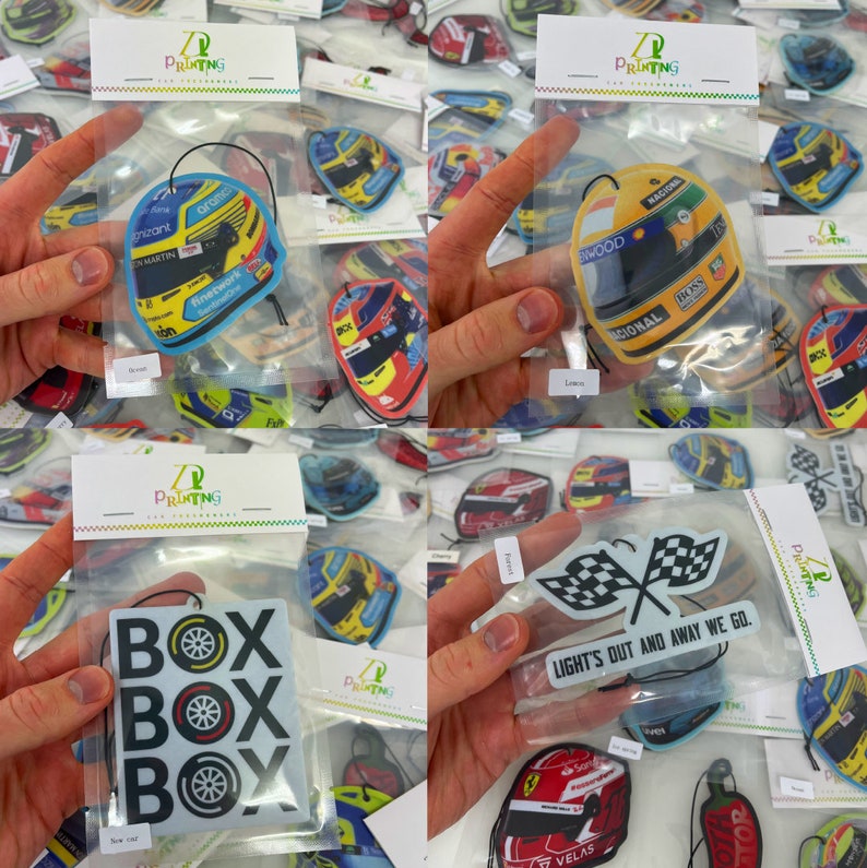 以下が含まれることがあります： レースをテーマにした車の芳香剤の詰め合わせ。芳香剤は、「Z Printing」と書かれたヘッダーカード付きの透明なビニール袋に入っています。デザインには、黄黒のレーシングヘルメット、チェッカーフラッグ、白黒のテキストデザインで「BOX BOX BOX」と書かれたものなどがあります。