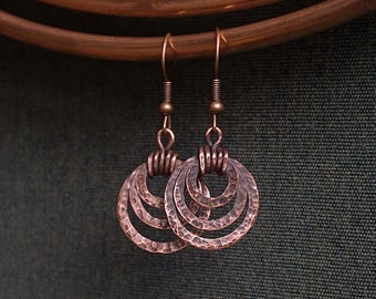 Rustic handmade copper earrings with hammered rings. Small and lightweight.