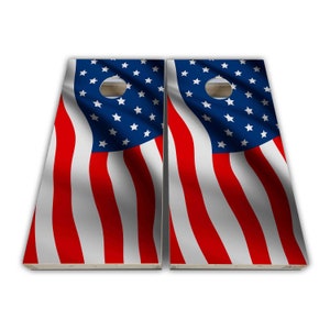 May include: A set of two wooden cornhole boards with a red, white, and blue American flag design. The boards are made of wood and have a hole in the center of each board.