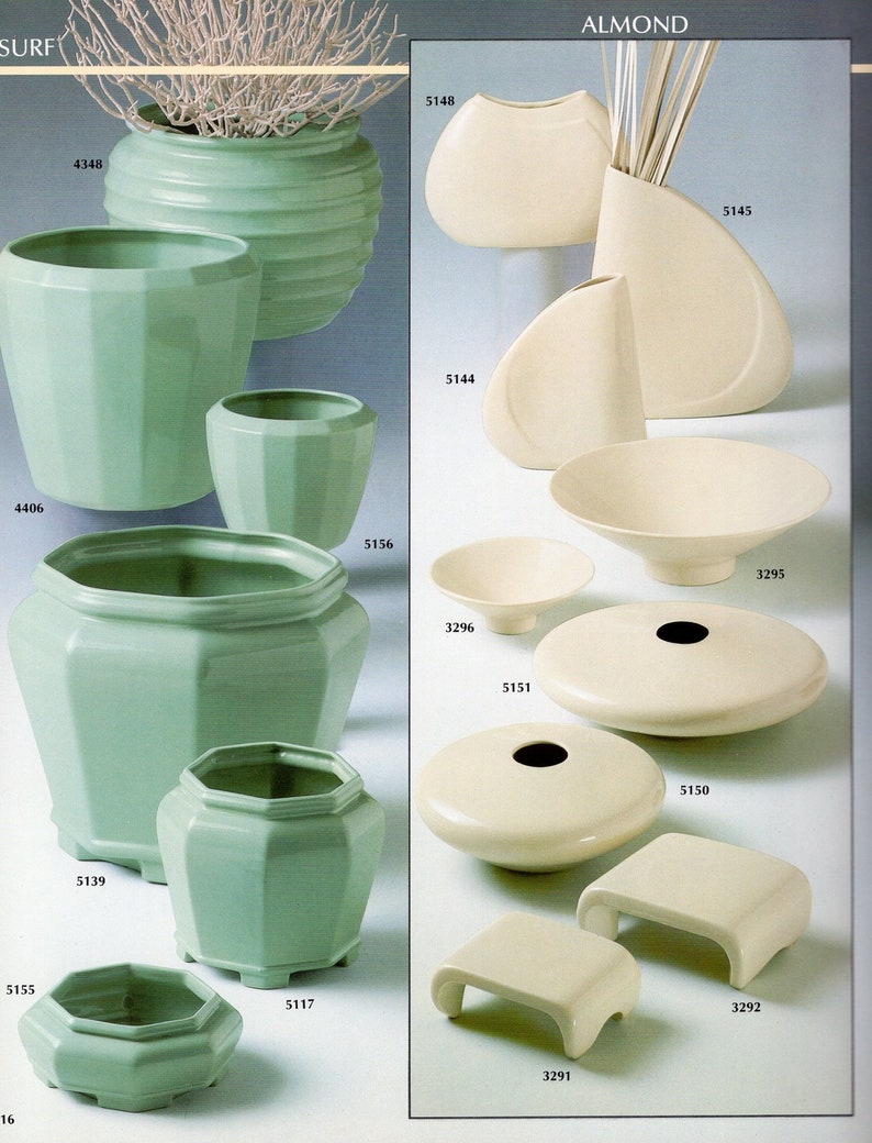 May include: A collection of ceramic vases and bowls in green and white. The vases are of various shapes and sizes, including a tall, cylindrical vase with a ribbed design, a shorter, round vase with a flared top, and a small, hexagonal vase. The bowls are also of various shapes and sizes, including a large, shallow bowl with a wide rim, a smaller, round bowl with a narrow rim, and a small, saucer-shaped bowl.