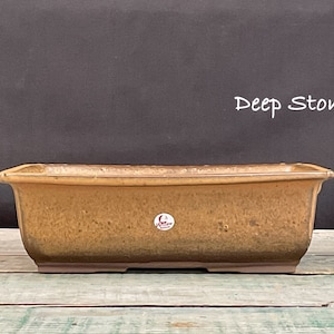 May include: A rectangular brown bonsai pot with a textured surface. The pot has a label that says "Deep Stone".