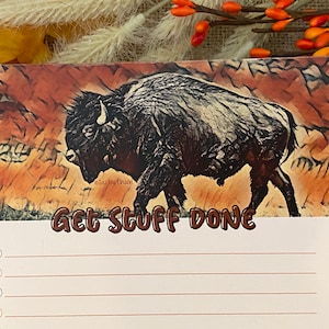 May include: A brown and white buffalo illustration on a notepad with the text "Get Stuff Done" and a blank checklist.