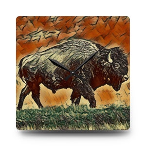 May include: A square clock with a brown bison silhouette on a textured orange and green background. The clock hands are black.