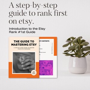 May include: A guide titled "The Guide to Mastering Etsy" with an orange cover and a table of contents. The cover features a hand holding a glass with a pink liquid. The guide is a step-by-step guide to master your Etsy business.