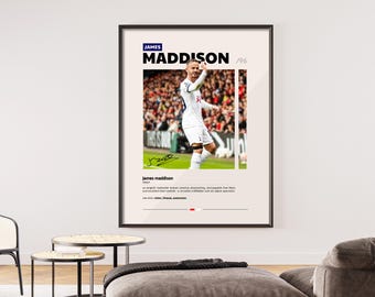 May include: A black and white poster featuring a soccer player in a white jersey with the number 10 on it. The poster has the text "JAMES MADDISON '96" at the top and a signature at the bottom. The poster is framed in a black frame.